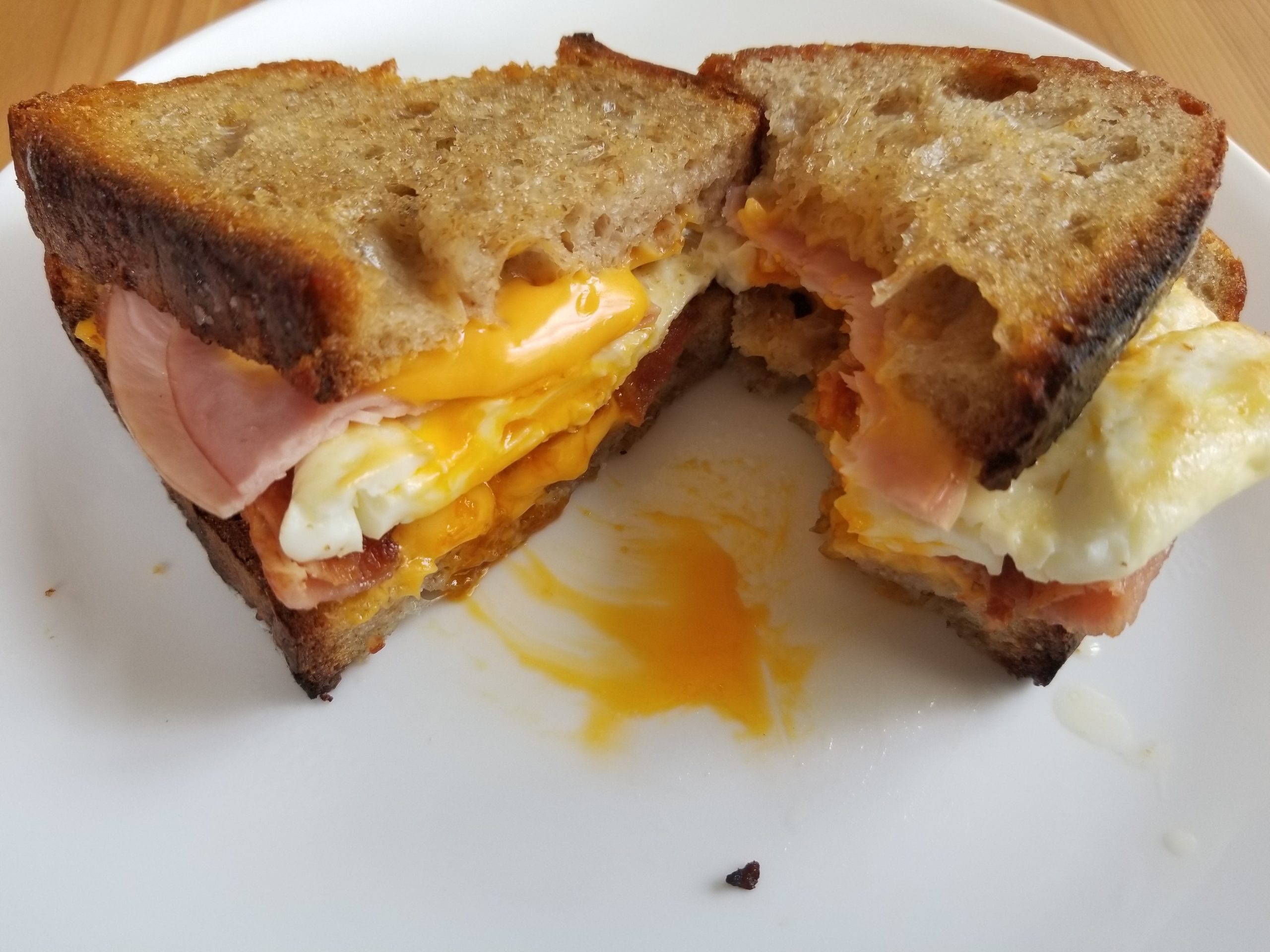 Bacon Over Easy Egg Ham And American Cheese On Butter Toasted Homemade Sourdough Dining