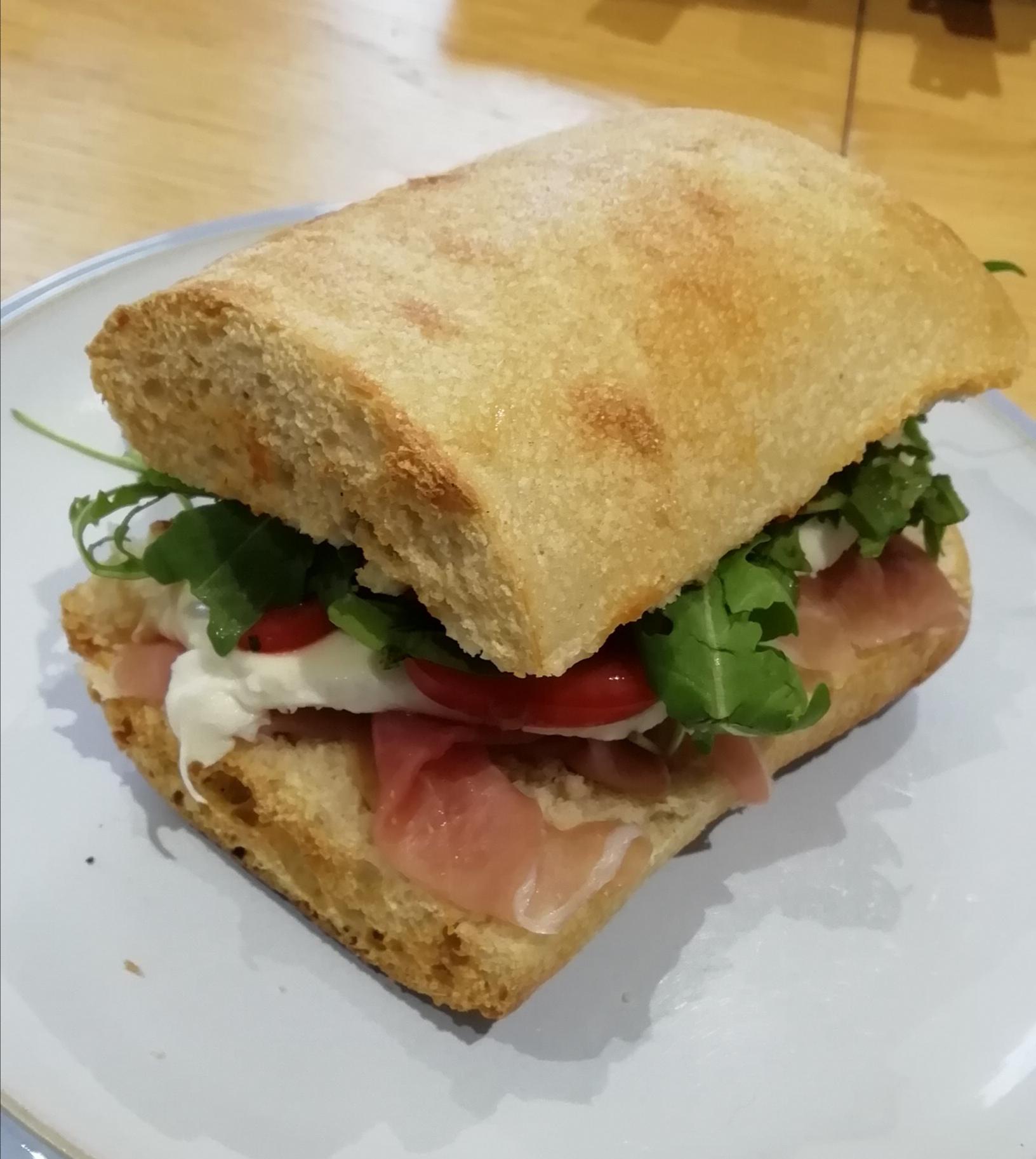 Prosciutto Mozzarella Tomato Rocket Arugula And Red Pesto In Ciabatta Bread Dining And