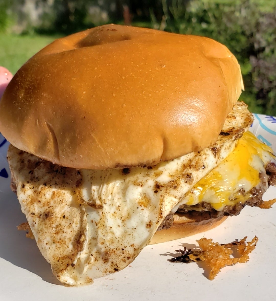 Fried egg smashburger on brioche off the griddle Dining and Cooking