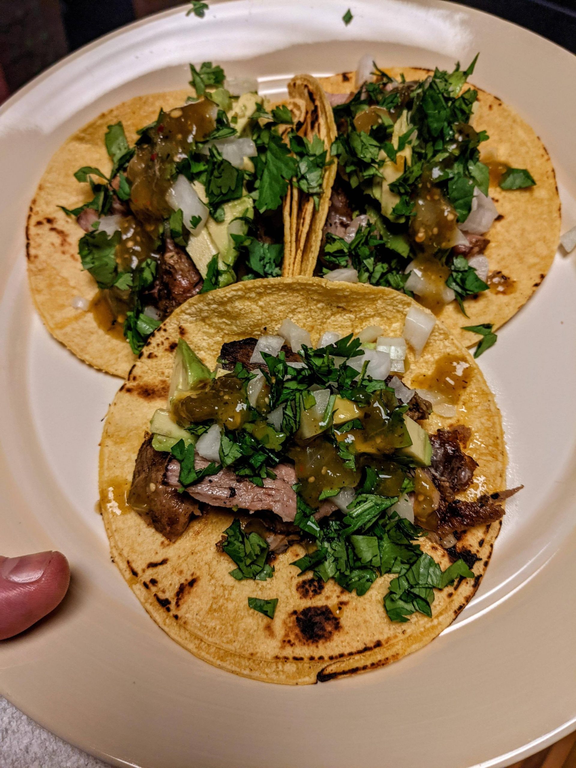 Crispy carnitas tacos with avocado, cilantro, onion and salsa verde 