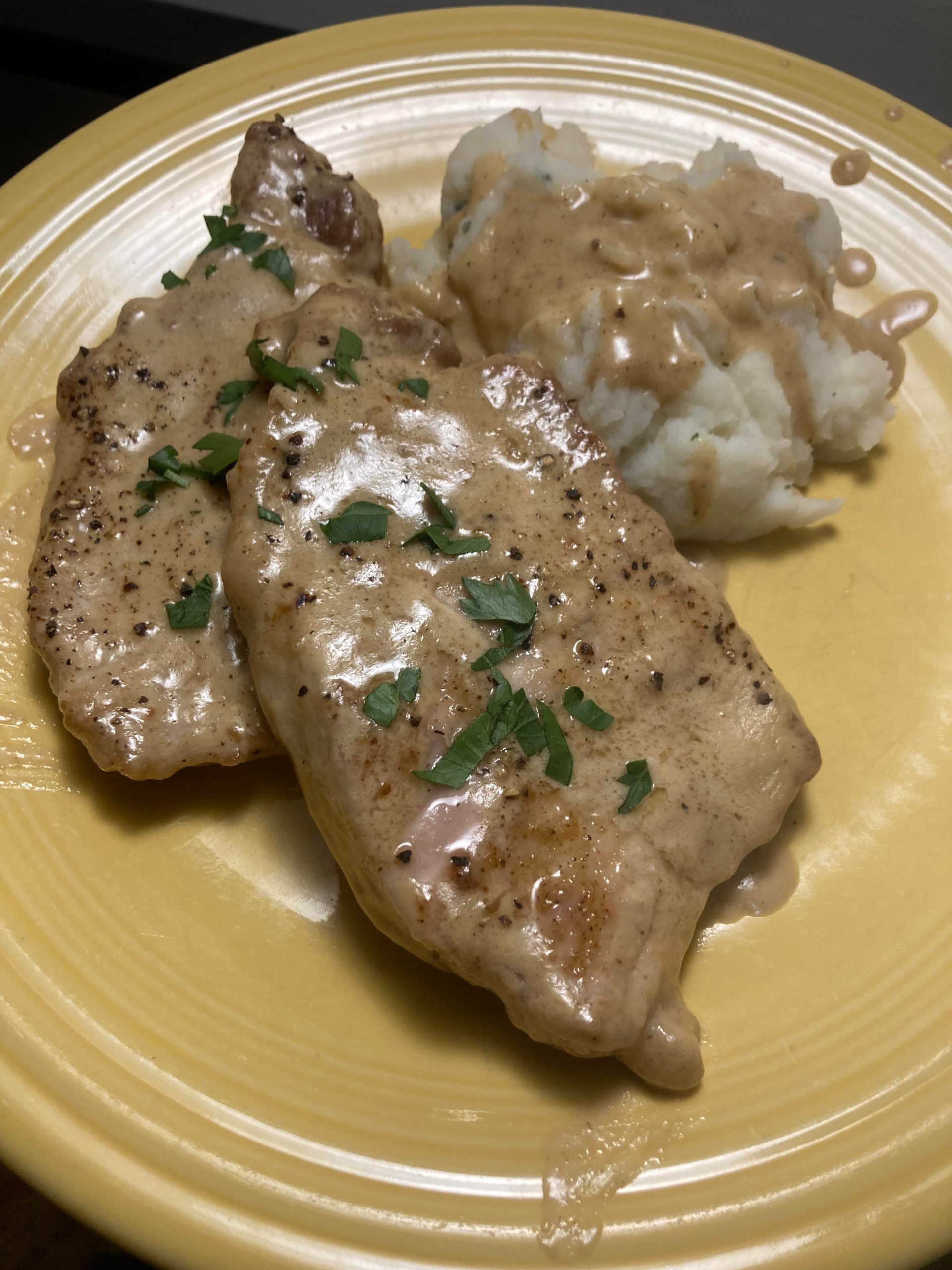 Smothered pork chops with a side of mashed potatoes. - Dining and Cooking