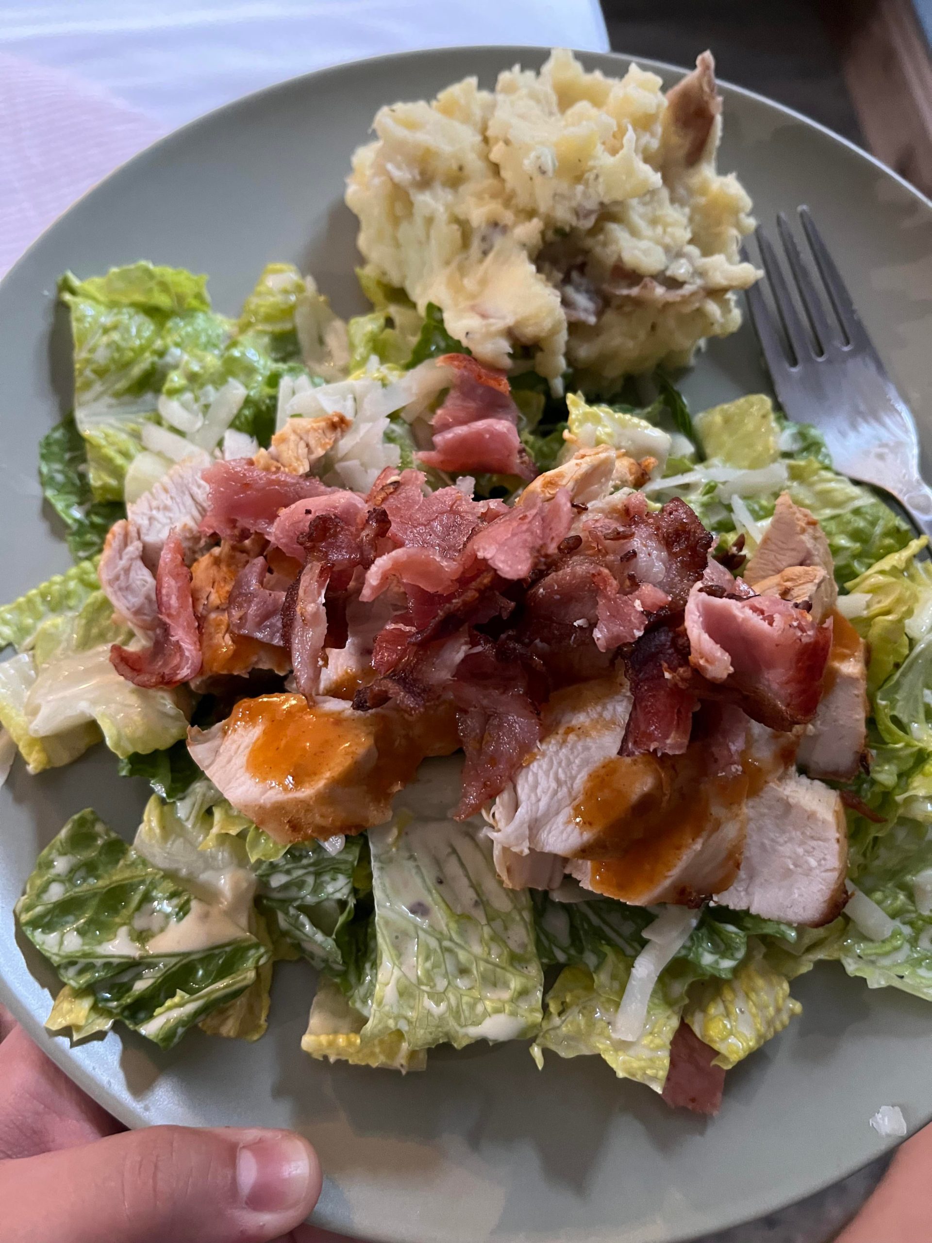 Caesar salad with chicken marinated in Nando’s sauce, bacon, and a side ...