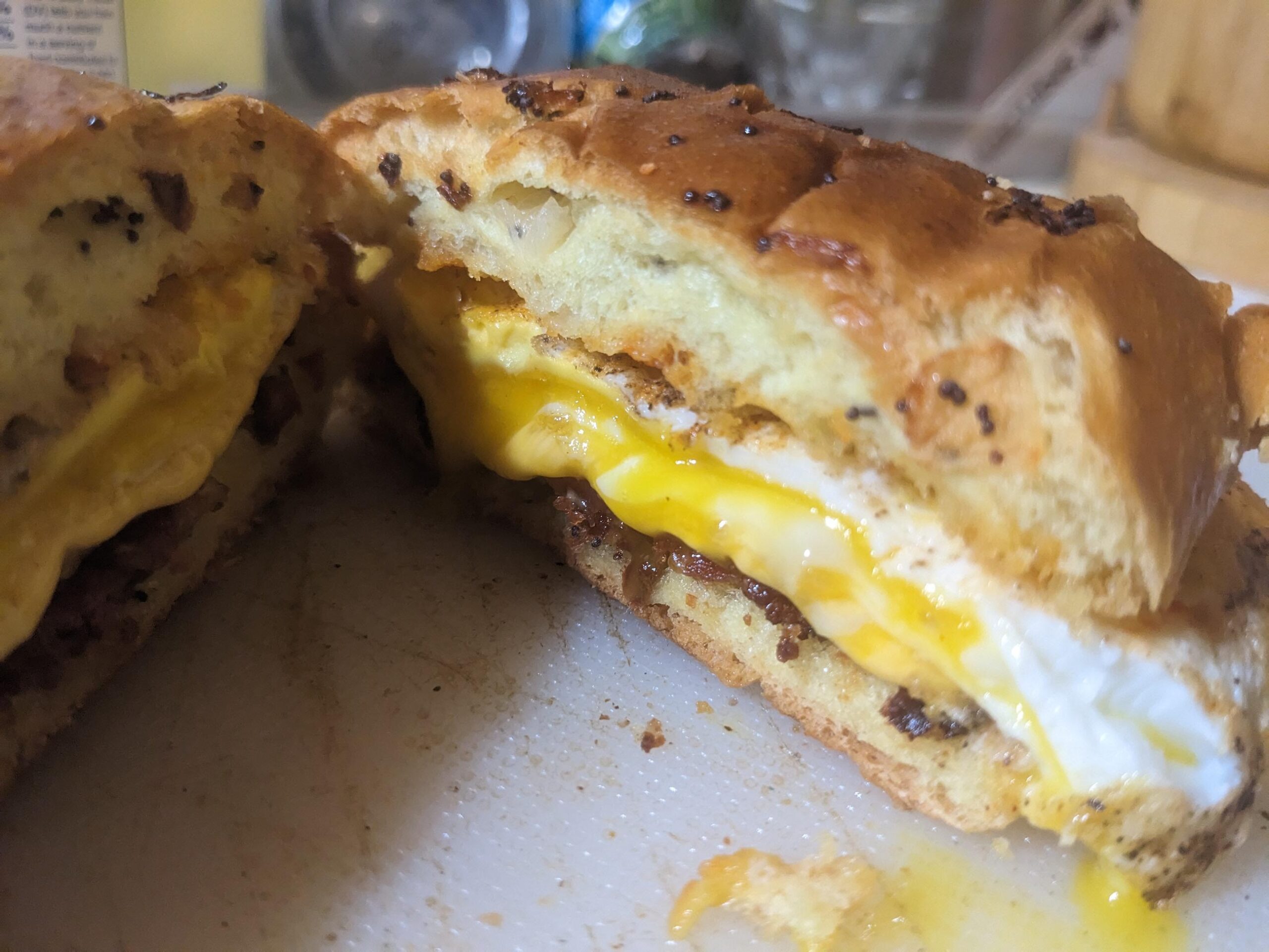 Crisp bacon, runny egg, and cheddar on a toasted onion roll. A fave ...