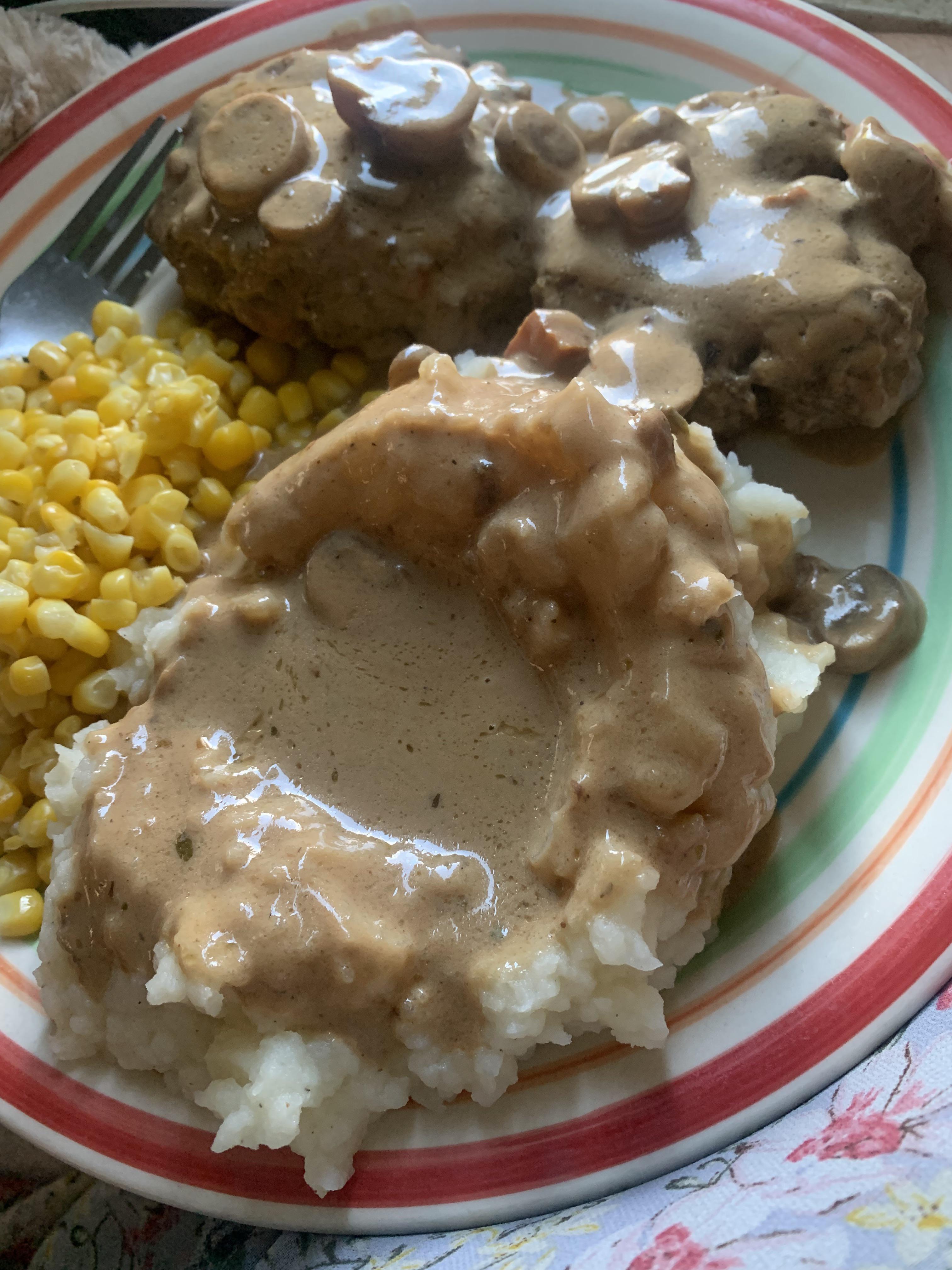 Smothered hamburger steaks with sour cream mushroom gravy, potatoes ...