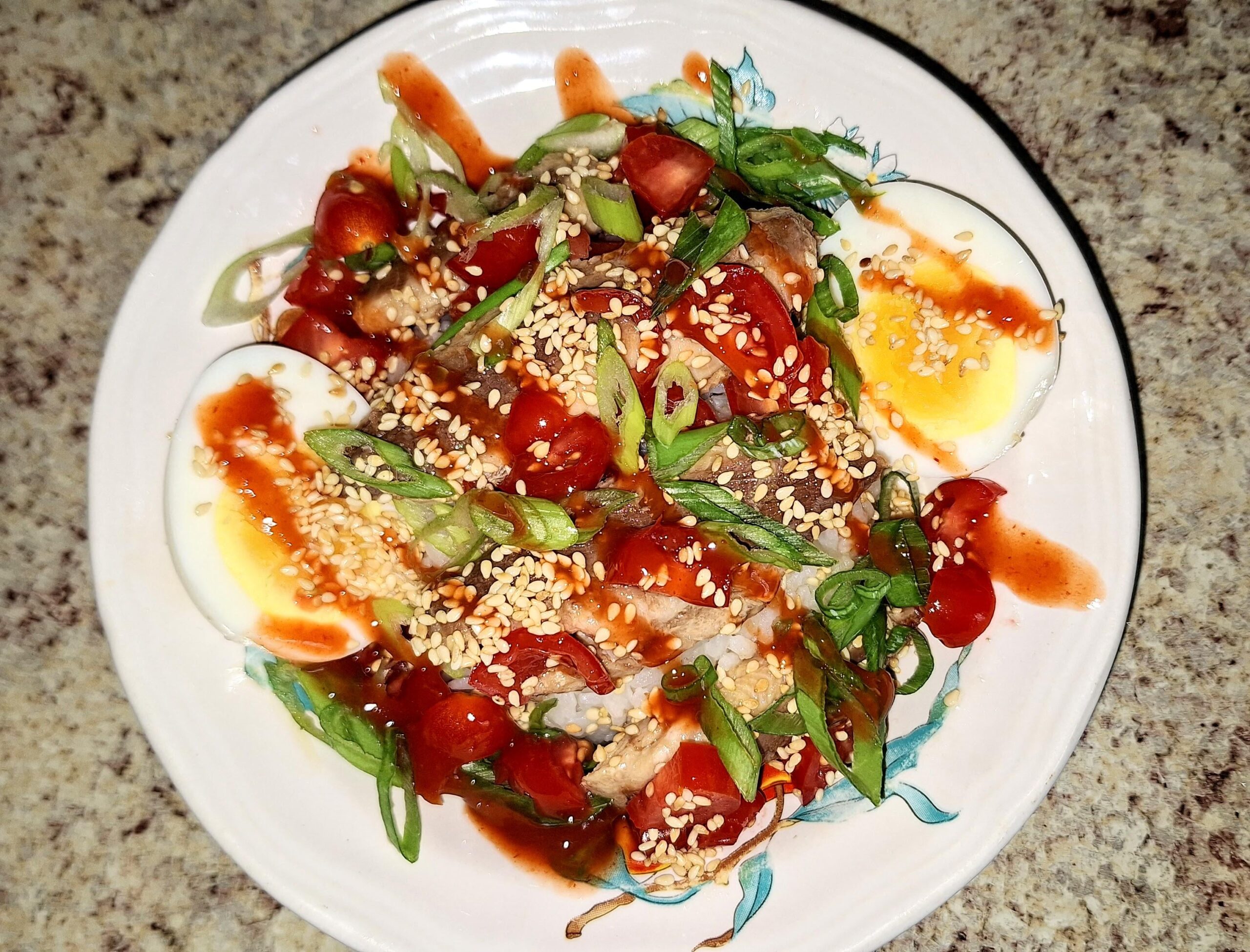 Sardine rice bowl with boiled egg, siracha, sesame seeds and oil, soy ...